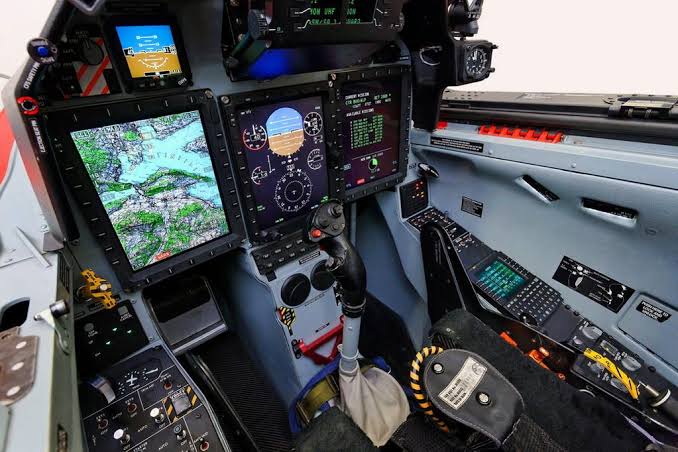 The forward cockpit instrument panel and control stick of a Pilatus PC-21 military training aircraft.